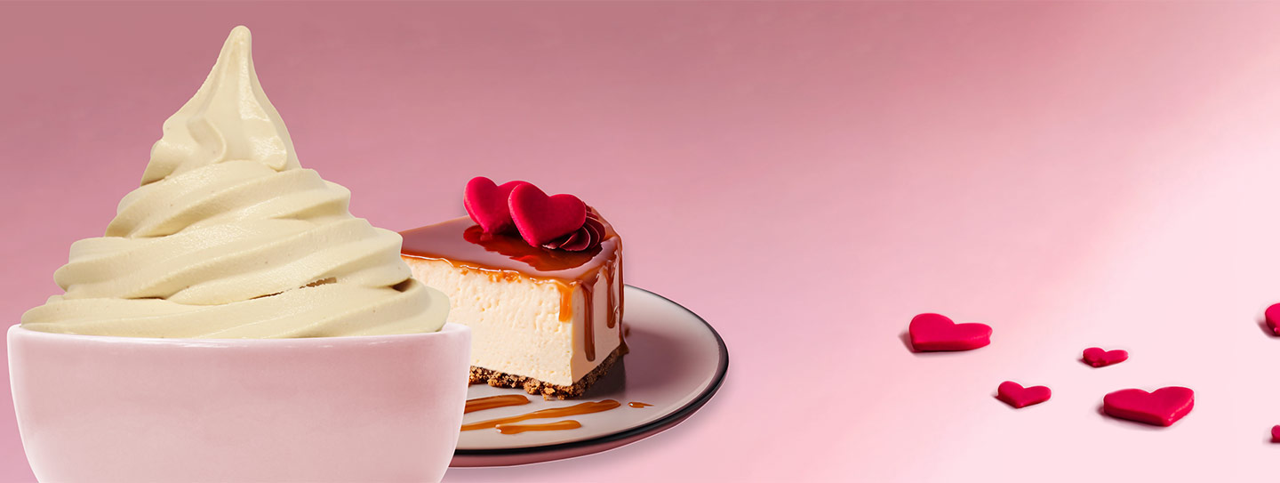 A cup of frozen yogurt alongside a slice of caramel cheesecake.