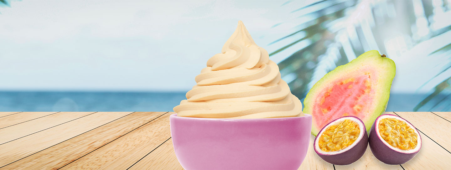 A cup of frozen yogurt alongside guava and passion fruit.