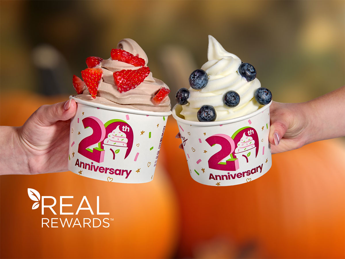 Two Yogurtland frozen yogurt cups with an assortment of toppings